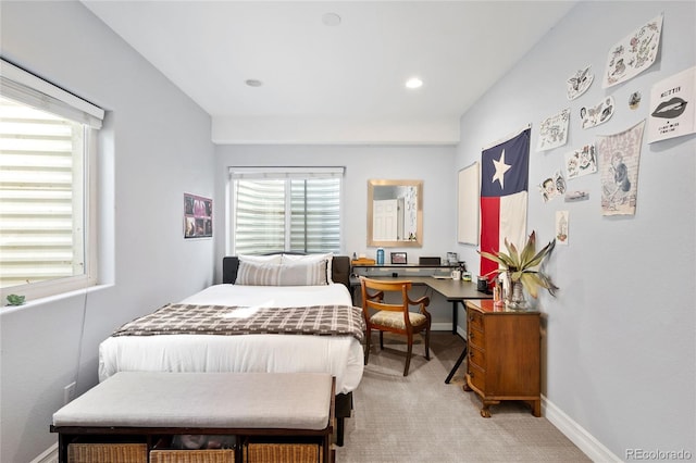 carpeted bedroom with multiple windows