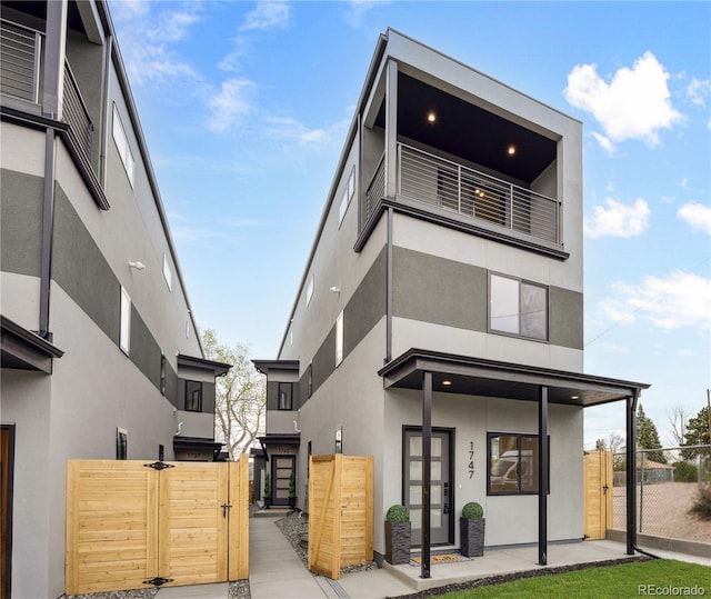 1745 Lowell Blvd, Denver, CO 80204 - exterior space featuring a balcony, fence, a gate, and stucco siding