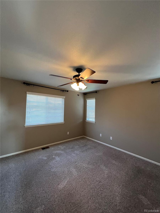 empty room featuring carpet floors and ceiling fan