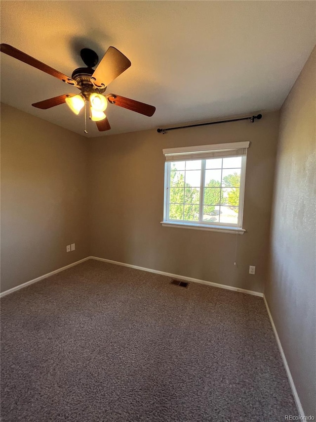 carpeted spare room featuring ceiling fan