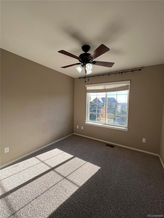 unfurnished room with ceiling fan and carpet flooring