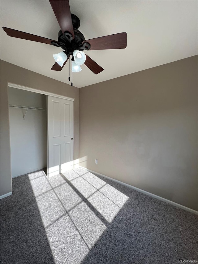 unfurnished bedroom with ceiling fan, a closet, and carpet flooring