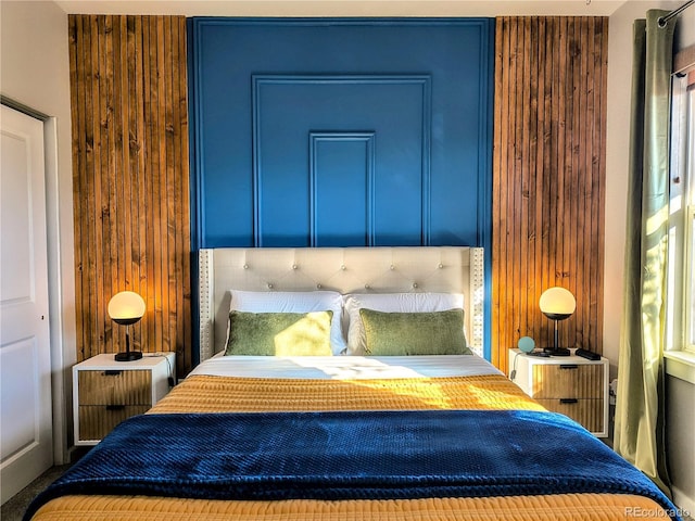 bedroom with wood walls