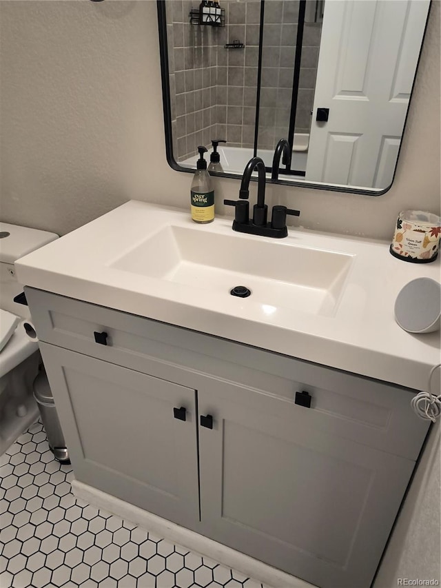 bathroom featuring vanity and toilet