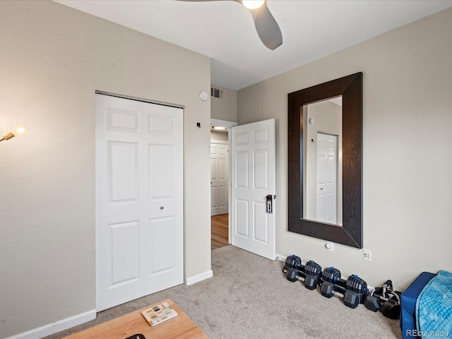 interior space with carpet flooring and ceiling fan