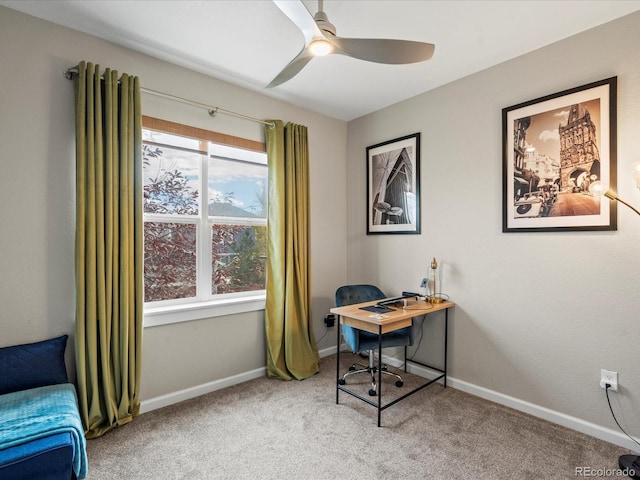 carpeted office space featuring ceiling fan