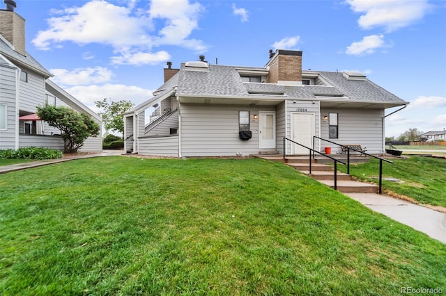 17004 E Tennessee Dr Unit 103, Aurora, CO 80017 - townhome / multi-family property with roof with shingles, a front lawn, and a chimney