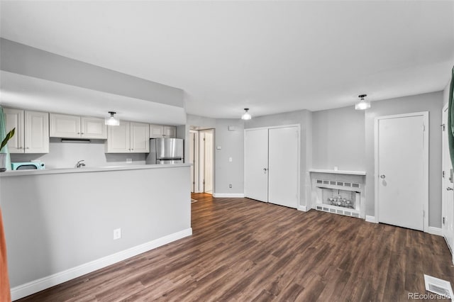17004 E Tennessee Dr Unit 103, Aurora, CO 80017 - unfurnished living room with dark wood-style flooring and baseboards