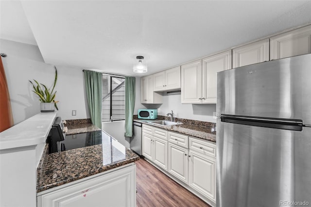 17004 E Tennessee Dr Unit 103, Aurora, CO 80017 - kitchen with stainless steel appliances, a sink, white cabinetry, and dark stone countertops