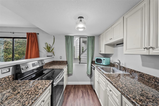 17004 E Tennessee Dr Unit 103, Aurora, CO 80017 - kitchen with stainless steel appliances, a sink, baseboards, dark wood-type flooring, and white cabinets