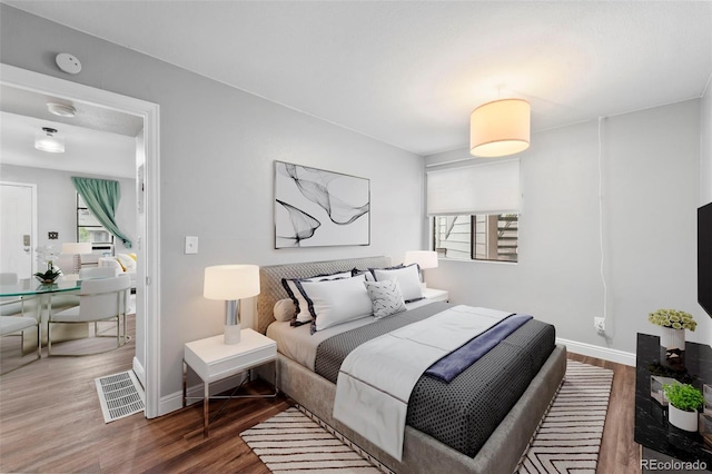 17004 E Tennessee Dr Unit 103, Aurora, CO 80017 - bedroom featuring wood finished floors and baseboards