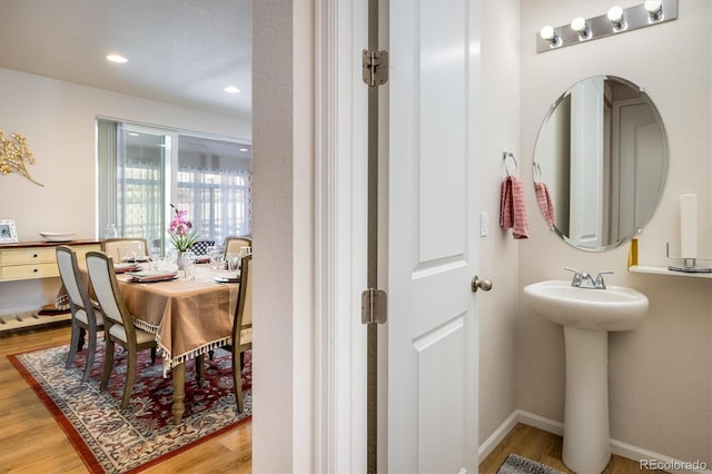 bathroom with hardwood / wood-style floors and sink