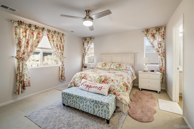 carpeted bedroom with ceiling fan and multiple windows