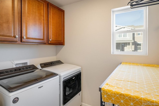 washroom featuring cabinets and independent washer and dryer