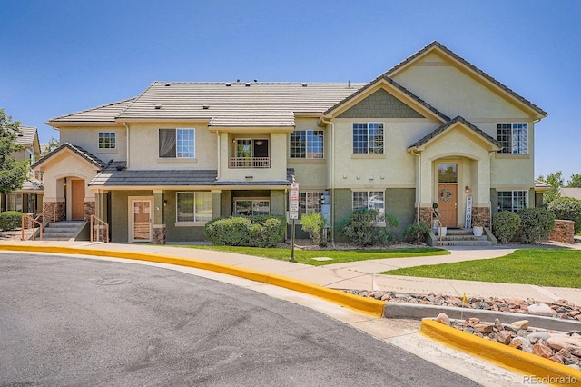 22560 E Ontario Dr Unit 204, Aurora, CO 80016 - townhome / multi-family property featuring stone siding, stucco siding, and a tiled roof