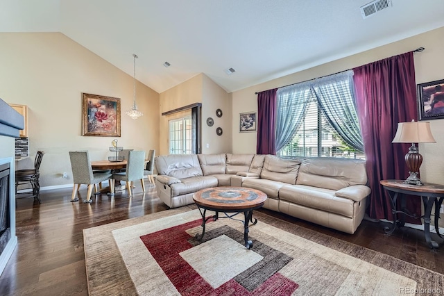 22560 E Ontario Dr Unit 204, Aurora, CO 80016 - living room featuring dark wood-type flooring, high vaulted ceiling, and a fireplace