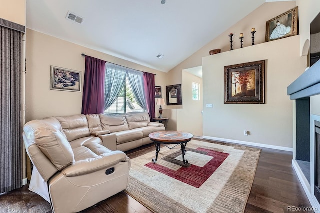 22560 E Ontario Dr Unit 204, Aurora, CO 80016 - living area featuring lofted ceiling, dark wood-style floors, and a fireplace