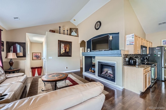 22560 E Ontario Dr Unit 204, Aurora, CO 80016 - living area with dark wood finished floors, arched walkways, high vaulted ceiling, and a glass covered fireplace