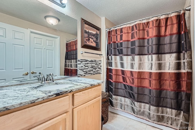 22560 E Ontario Dr Unit 204, Aurora, CO 80016 - bathroom with vanity, a textured ceiling, tile patterned flooring, and curtained shower