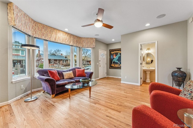 living area featuring recessed lighting, baseboards, wood finished floors, and a ceiling fan