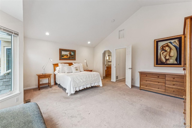 bedroom with baseboards, carpet floors, and arched walkways