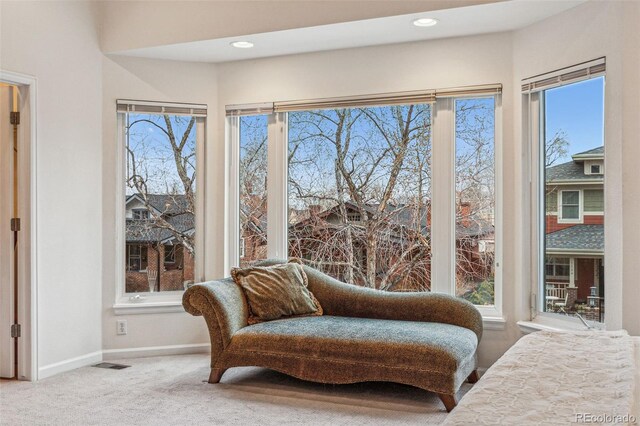 living area with recessed lighting, visible vents, baseboards, and carpet