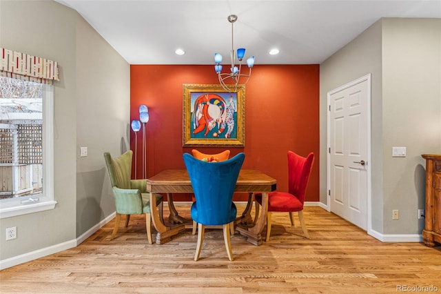 dining space featuring a notable chandelier, recessed lighting, wood finished floors, and baseboards