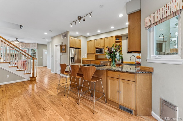 kitchen with visible vents, appliances with stainless steel finishes, open shelves, and a sink