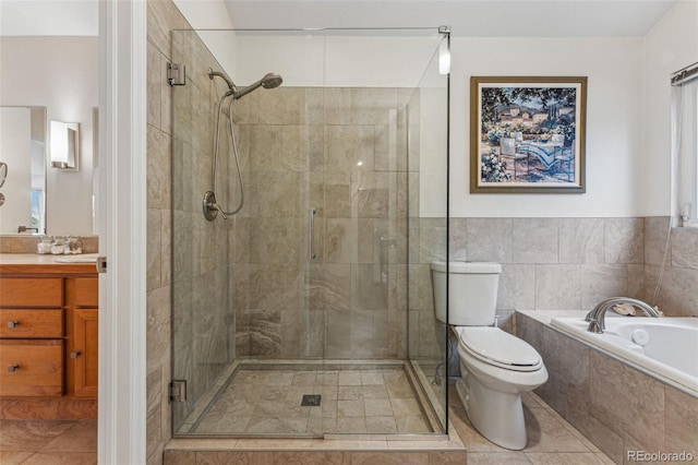 bathroom featuring vanity, toilet, a bath, and a shower stall