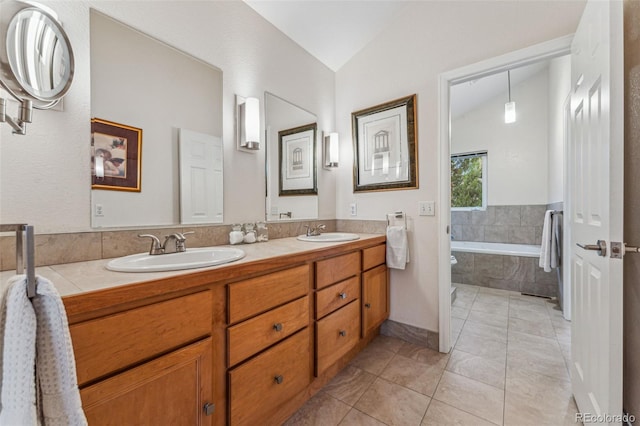 bathroom with a sink, lofted ceiling, double vanity, and tile patterned flooring