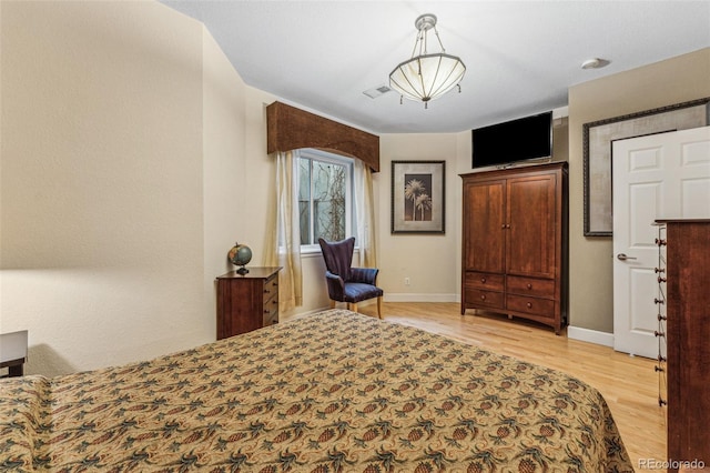 bedroom with visible vents, baseboards, and light wood-style floors