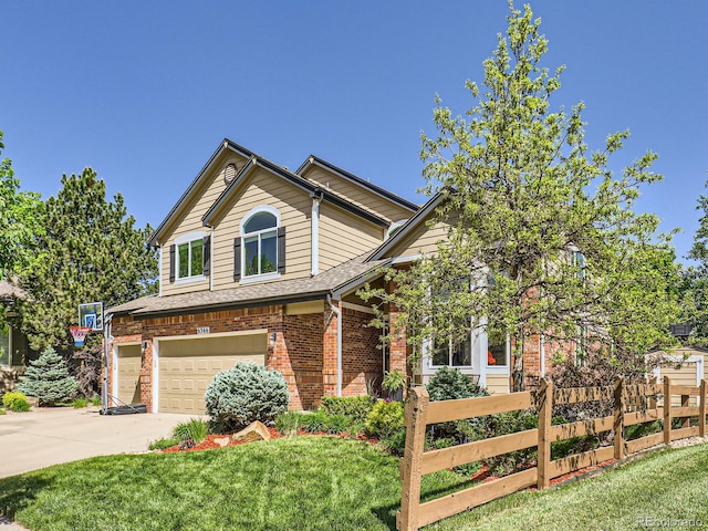 6366 Umber Cir, Arvada, CO 80403 - view of front facade featuring a garage, brick siding, and driveway