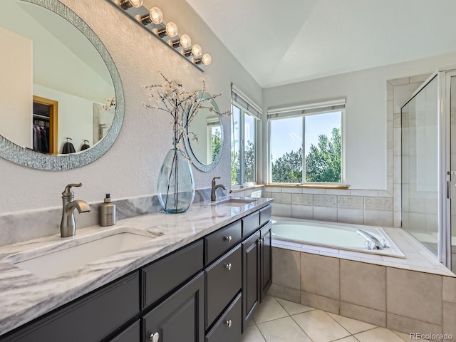 6366 Umber Cir, Arvada, CO 80403 - bathroom with tile patterned floors, a bath, double vanity, a shower stall, and a textured wall