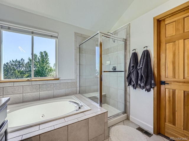 6366 Umber Cir, Arvada, CO 80403 - bathroom with a shower stall, a garden tub, vaulted ceiling, baseboards, and tile patterned floors