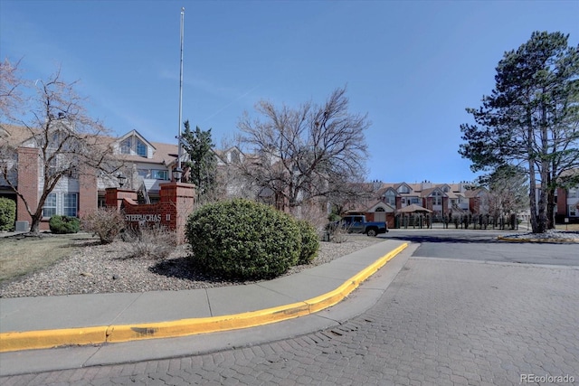 view of road with curbs, sidewalks, and a residential view