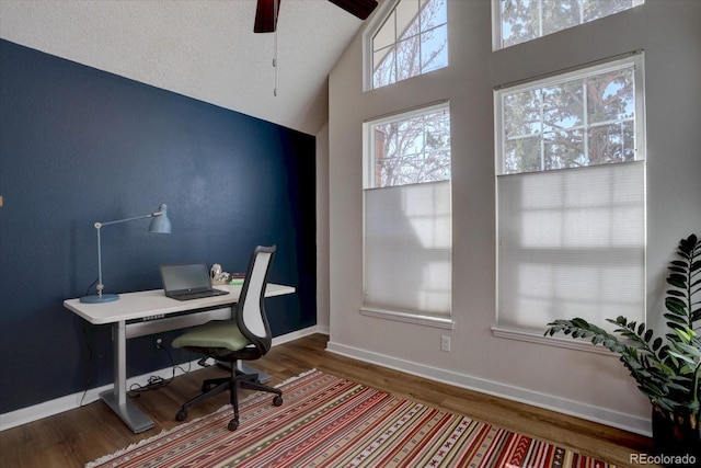 office space with a textured ceiling, baseboards, wood finished floors, and a ceiling fan