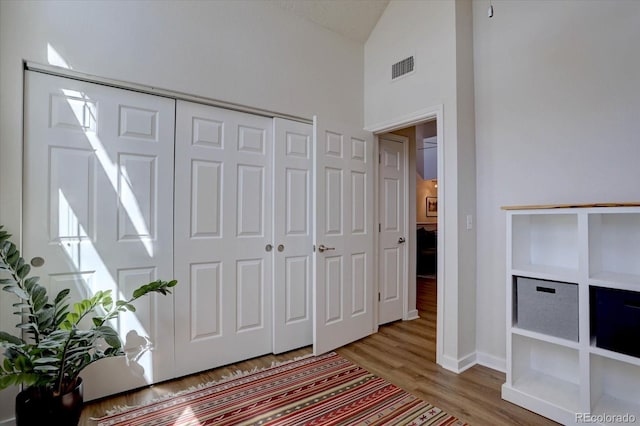 entryway with baseboards, visible vents, and wood finished floors
