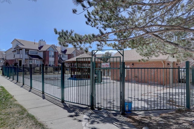 view of gate with a residential view and fence
