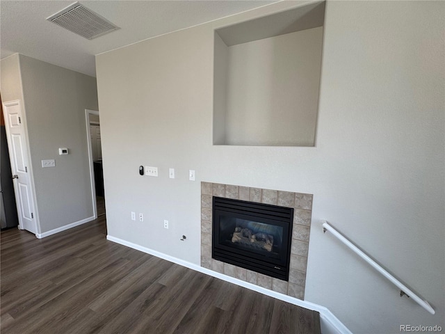 13013 Grant Cir Unit C, Thornton, CO 80241 - unfurnished living room featuring wood finished floors and a tile fireplace