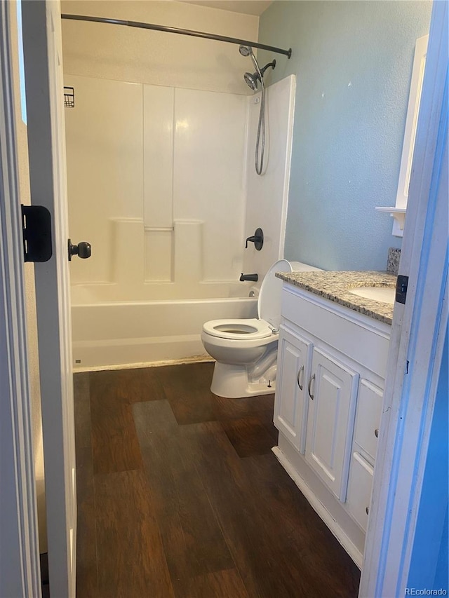 full bathroom with shower / bathtub combination, wood-type flooring, toilet, and vanity