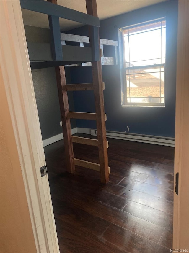 unfurnished bedroom with dark hardwood / wood-style flooring