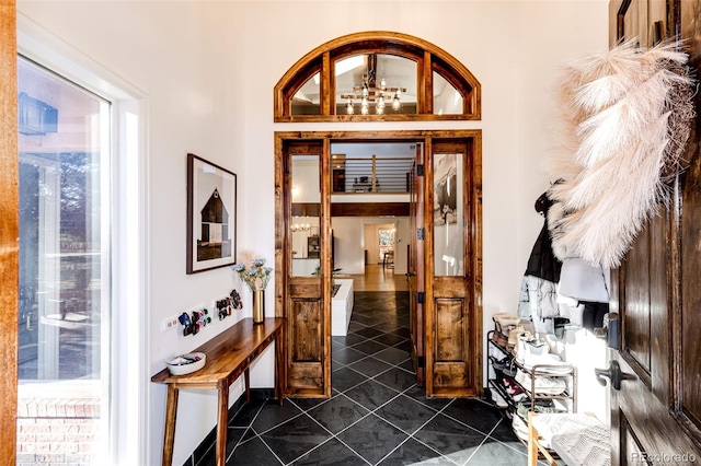 foyer entrance with dark tile patterned flooring