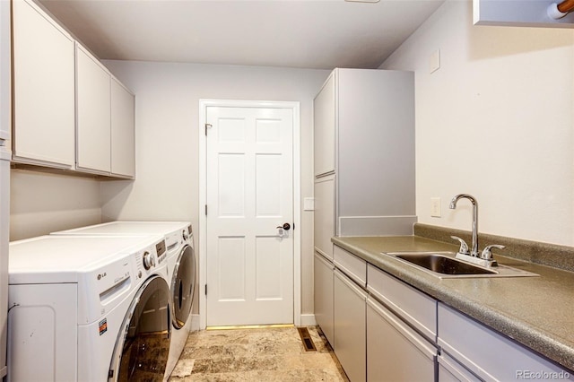 laundry area with a sink, cabinet space, and washer and dryer