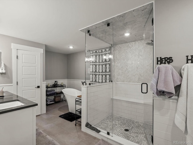 280 E 11th Ave, Broomfield, CO 80020 - full bath featuring a stall shower, a freestanding tub, vanity, a wainscoted wall, and recessed lighting