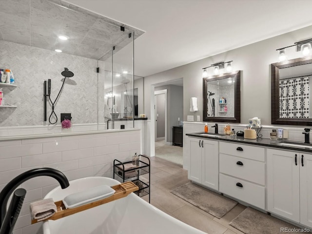 280 E 11th Ave, Broomfield, CO 80020 - bathroom with a stall shower, a freestanding bath, double vanity, and tile patterned flooring