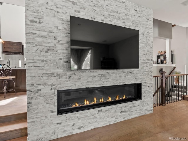 280 E 11th Ave, Broomfield, CO 80020 - detailed view of a stone fireplace and wood finished floors