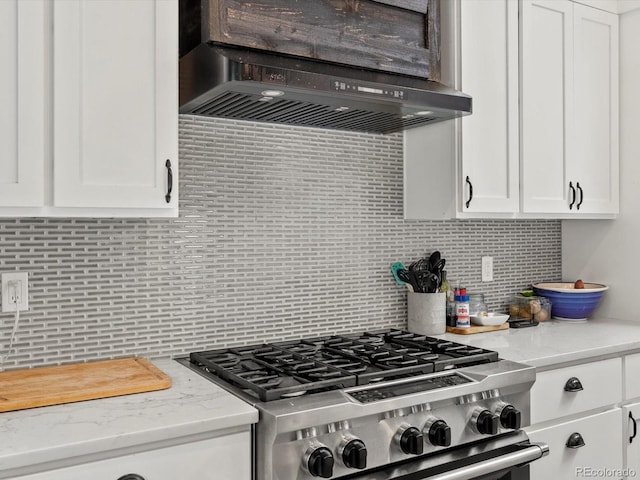 280 E 11th Ave, Broomfield, CO 80020 - kitchen with stainless steel gas range, custom range hood, decorative backsplash, and white cabinetry