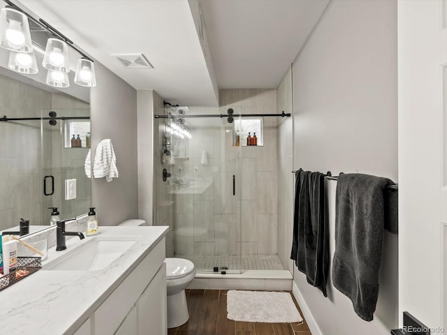 280 E 11th Ave, Broomfield, CO 80020 - bathroom featuring vanity, a shower stall, and wood finished floors