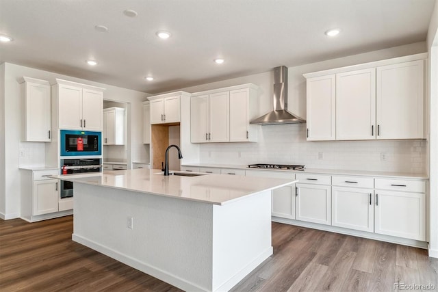 25284 E Warren Pl, Aurora, CO 80018 - kitchen with stainless steel oven, wall chimney range hood, dark wood-style floors, white cabinets, and recessed lighting
