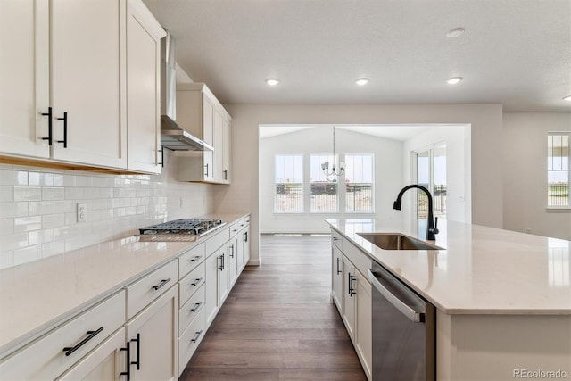 25284 E Warren Pl, Aurora, CO 80018 - kitchen featuring stainless steel appliances, wall chimney range hood, dark wood-style flooring, tasteful backsplash, and recessed lighting